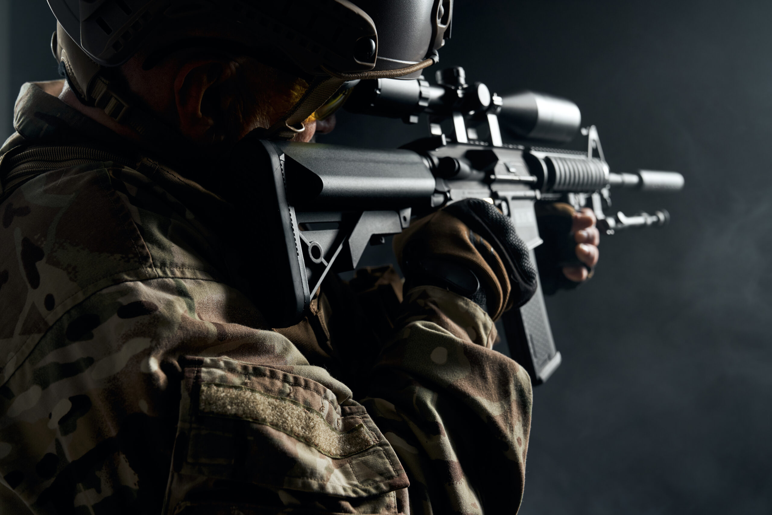 Old soldier in uniform pointing with sniper rifle.